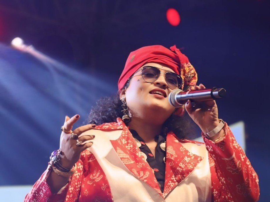 Dr. Jayashree Dhal performing on stage in red costume