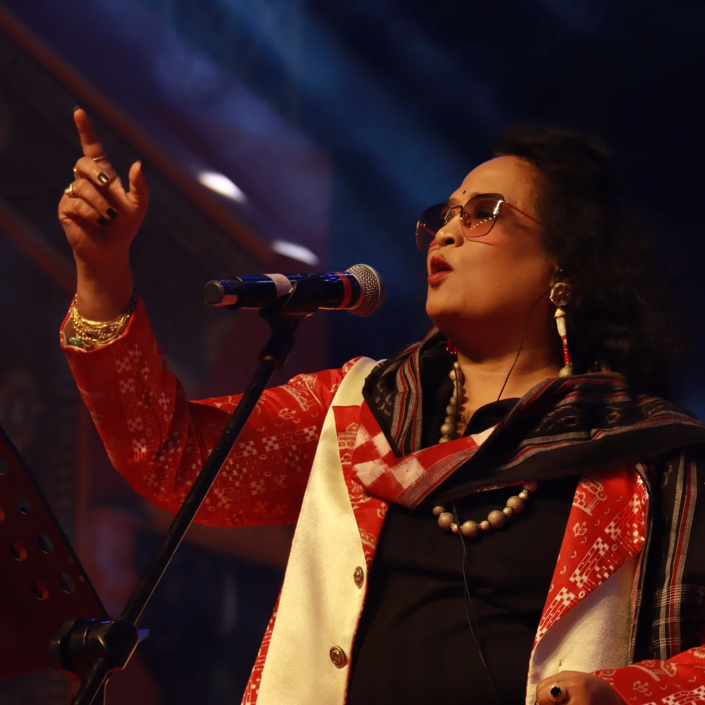 Dr. Jayashree Dhal singing during a live stage performance